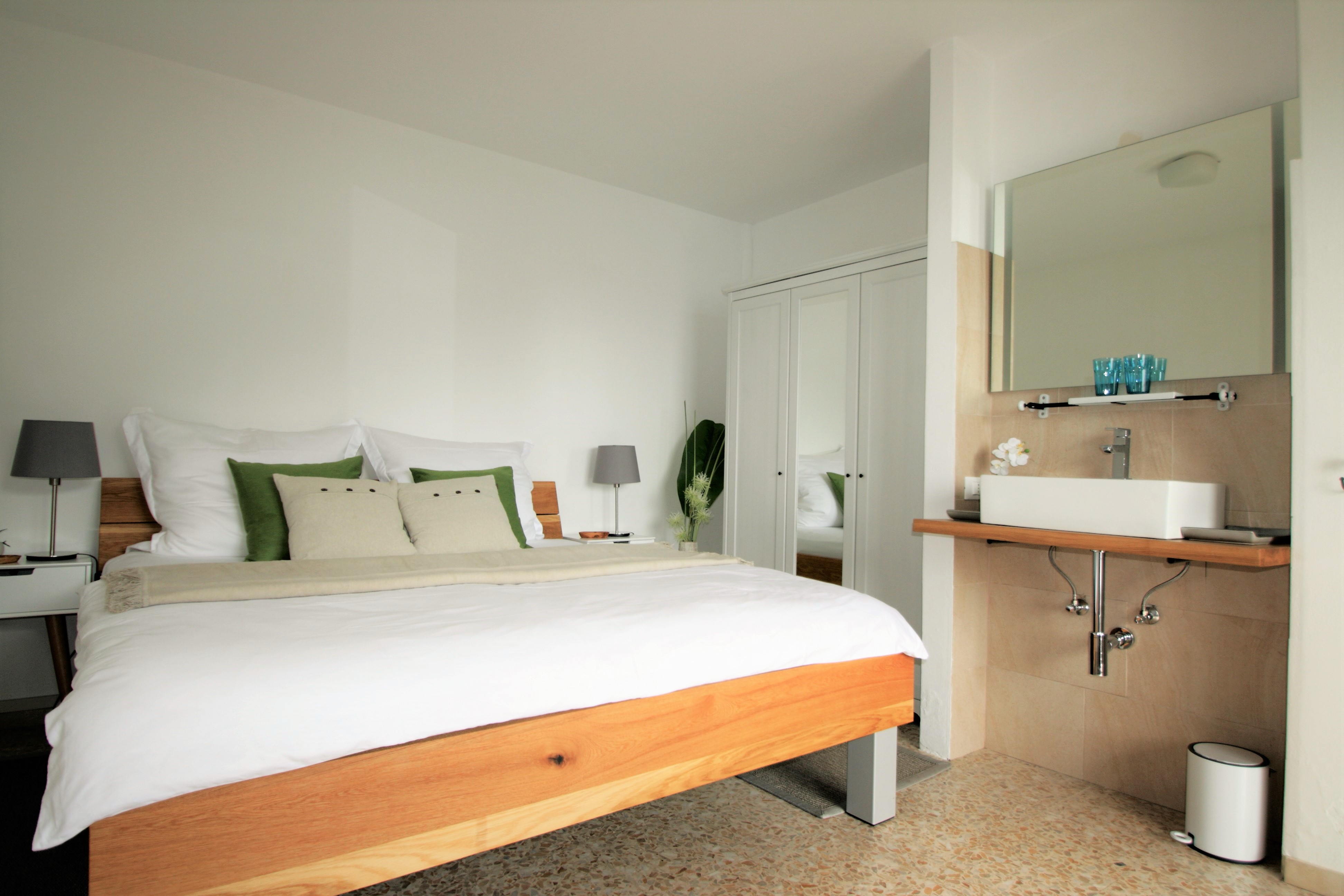 Schlafzimmer mit Doppelbett und eigenem Waschbereich in Casa Valle